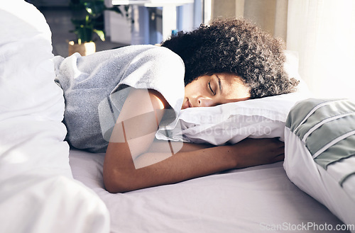 Image of Sleep, bedroom and relax with a black woman in bed, dreaming or resting in the morning at home. Sleeping, tired and rest with an attractive young female asleep in her house over the weekend