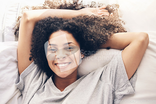 Image of Black woman, top view and wake up portrait in bedroom after sleeping in the morning. Peace, bed relax and comfort of happy female awake after sleep on comfortable pillow and blankets for healthy rest