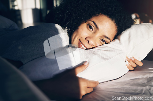 Image of Portrait, woman in bed and morning with sunlight, smile and ready to start the day, rested and fresh. Face, female and lady in bedroom, sunshine and happiness for vacation, pillow or wake up with joy