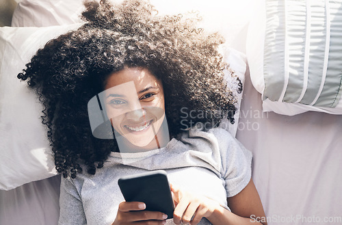 Image of Black woman, phone and top view in home bedroom for social media, texting or internet browsing in the morning. Portrait, bed relax and female with mobile smartphone for web scrolling or networking.