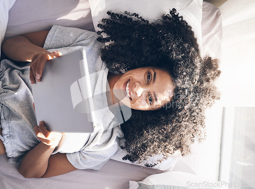 Image of Tablet, black woman and top view in bed in bedroom for social media, texting or internet browsing in the morning. Portrait, relax and female on digital touchscreen for web scrolling or networking.