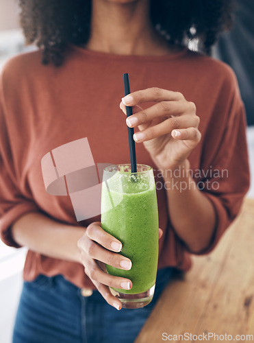 Image of Hands, glass and smoothie with a black woman drinking a health beverage for a weight loss diet or nutrition. Wellness, glass and drink with a healthy female enjoying a fruit beverage at home