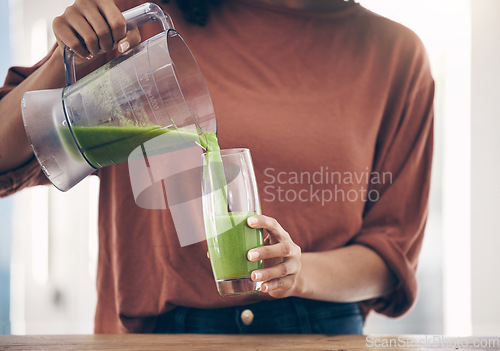 Image of Green, smoothie and hands of woman with a drink in the kitchen for breakfast, detox and diet. Hand, nutritionist and lady with fresh, weight loss and healthy, raw and vegan lifestyle, shake and juice