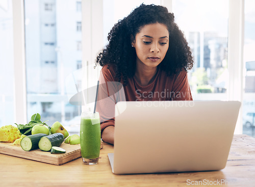 Image of Relax, smoothie and health with black woman and laptop for blog research, salad and vegetables. Nutritionist, diet and food with girl by kitchen counter for cooking, technology and learning at home