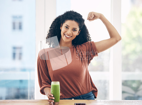 Image of Portrait, muscle and smoothie with a black woman in the kitchen of a home flexing her bicep for health. Wellness, weight loss and strong with an attractive young female drinking a diet beverage