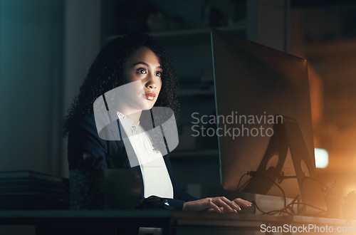 Image of Night, office and black woman on computer for business project, management report and online document. Corporate worker, overtime and focused female working on strategy, planning and website research