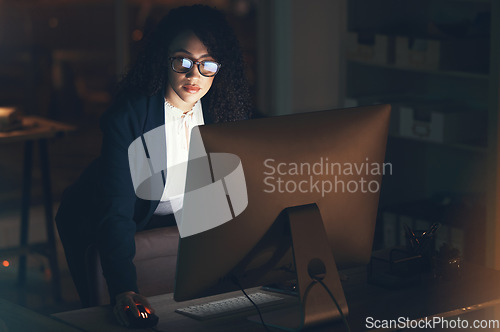 Image of Business, night and black woman done on computer for project, strategy report and reading email. Corporate manager, dark office and female standing at desk working on schedule, planning and research