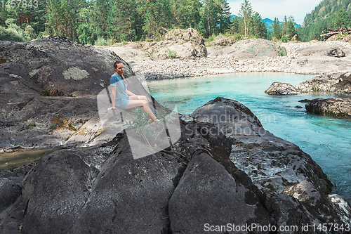 Image of Woman resting at river