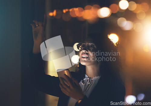 Image of Business woman, phone and night in dark office for communication, network connection and trading. Entrepreneur person with smartphone and bokeh lights for networking, internet search or ai mobile app