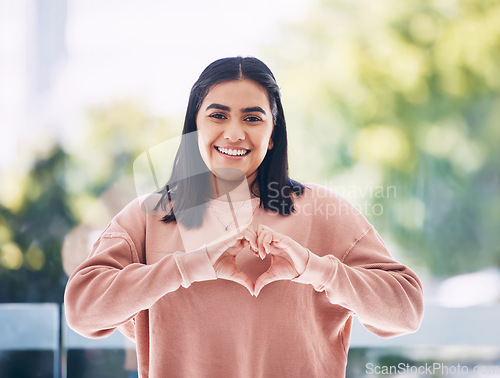 Image of Portrait, heart hands and young woman for self care, cardiology wellness and gen z support for women health. Face of a happy Indian person with love emoji, sign or gesture for like, vote and peace