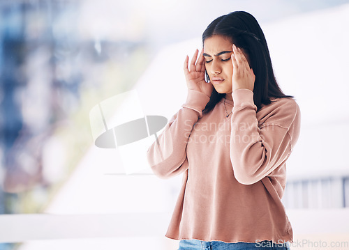 Image of Headache, burnout or mockup with an indian woman on a blurred background suffering from pain or stress. Compliance, mental health or anxiety and a frustrated young female struggling with a migraine