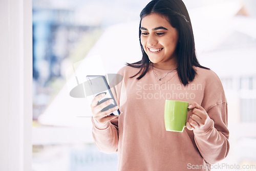 Image of Woman, phone or drinking coffee in house, home or penthouse apartment on social media app, internet or dating website. Happy smile, student and relax tea cup, mobile blog or communication technology