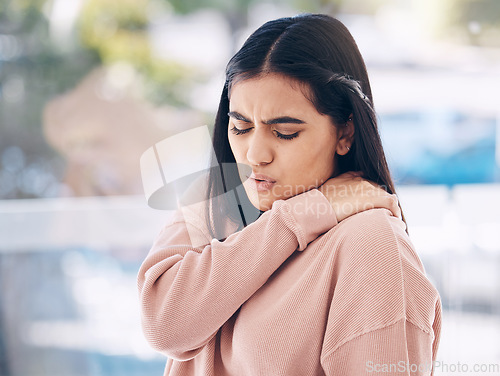 Image of Neck, pain and mockup with an indian woman holding her shoulder on a glass background while suffering from cramp. Medical, anatomy or muscle and an attractive young female struggling with an injury