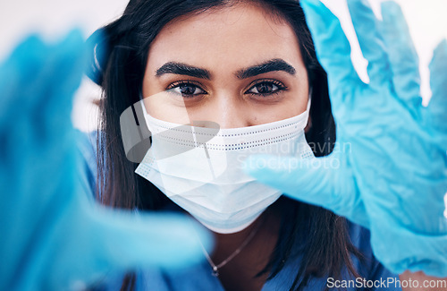 Image of Doctor, gloves and face in frame with face mask for covid exam or surgery focus. Closeup portrait of woman medical expert, surgeon or nurse with latex hands ready in checkup examination