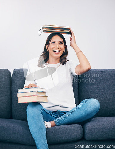 Image of Happy student or woman with books balance on head of study, education or university time management and reading. Knowledge, learning and college person on sofa with history, philosophy or scholarship