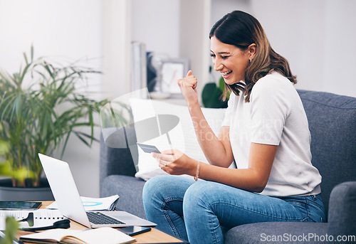 Image of Success, laptop or winner excited with credit card or digital payment in celebration on sofa at home. Yes, finance or happy girl celebrates online shopping subscription discount, sales offer or deal