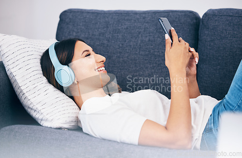 Image of Headphones, phone and sofa woman or student with meme video, internet chat and music for mental health and relax. Smartphone of person on couch streaming, listening to audio or a funny podcast online