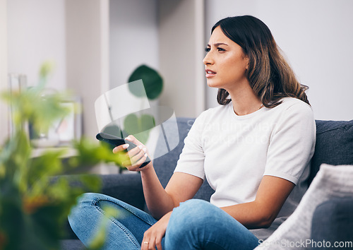 Image of Woman confused, watching tv and remote control, relax at home and squint with vision problem and streaming movie. Thinking, entertainment and confusing television show with young person in lounge