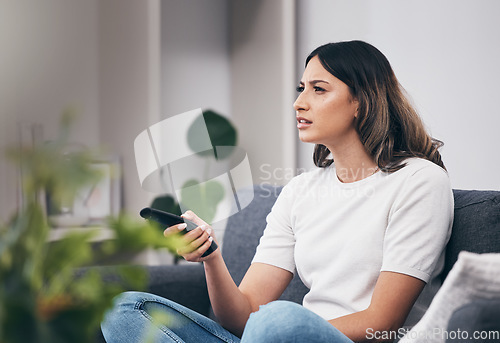 Image of Woman confused watching tv, streaming with remote control and relax at home, thinking or vision problem with squint. Entertainment with leisure in living room and confusing television show or film