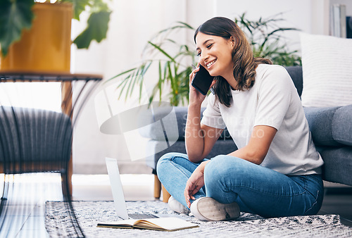 Image of Woman, phone call and laptop with notebook in the living room by sofa in remote work or studying at home. Happy female freelancer in conversation or discussion on smartphone and computer on the floor