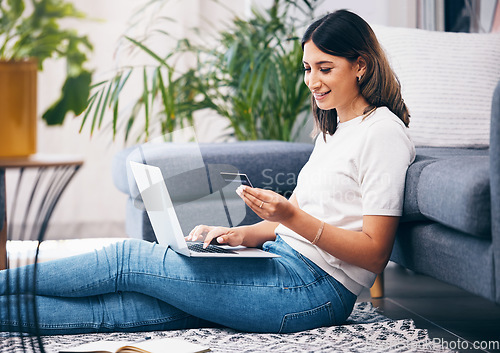 Image of Credit card, online shopping and woman on laptop, banking and fintech for easy payment on home carpet. Young person or student with computer for e commerce sale, finance and wealth in her living room