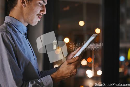 Image of Businessman, night and office with tablet in hands for research, market analysis and communication at job. Man, mobile touchscreen ux and reading for data analytics, progress and growth of company