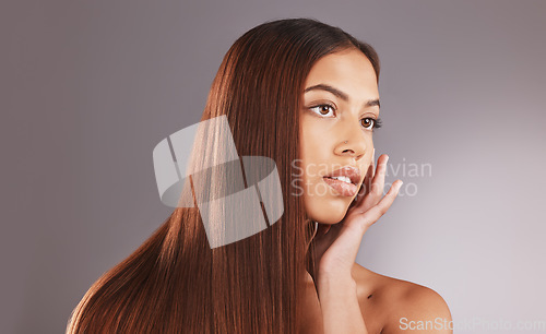 Image of Woman, long hair and face for skincare, facial or beauty cosmetics against a gray studio background. Attractive female touching skin in self love or haircare for cosmetic keratin treatment on mockup