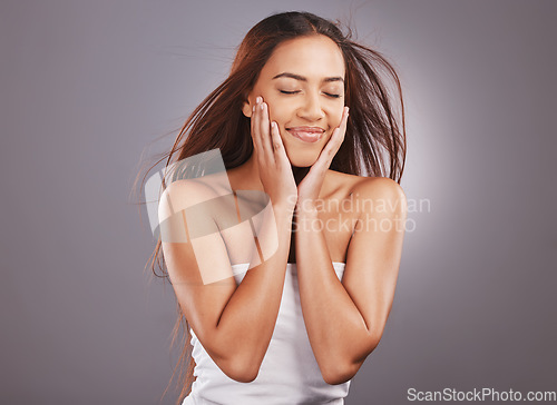 Image of Beauty, hair and cosmetics by woman with skincare, self care and haircare isolated in a studio gray background. Face, facial and salon by natural female model with makeup and promote product