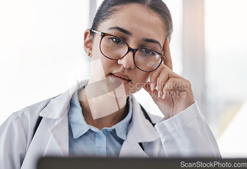 Image of Tired doctor, laptop or woman medical student reading online credit debt, email or university outstanding bills. Financial crisis, sad or nurse face on tech for hospital payment agenda or compliance