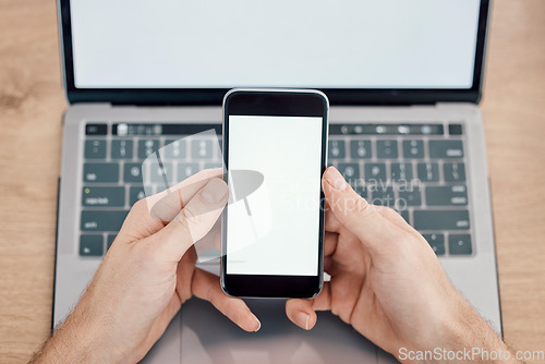 Image of Hands, phone and laptop on mockup screen for networking, social media or mobile app at office desk. Hand of person with display on smartphone for online advertising, branding logo or marketing