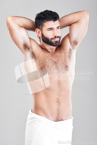 Image of Skincare, towel and man with cosmetics, thinking and natural beauty on grey studio background. Male, guy and hygiene for confidence, morning routine and grooming for treatment, luxury and dermatology