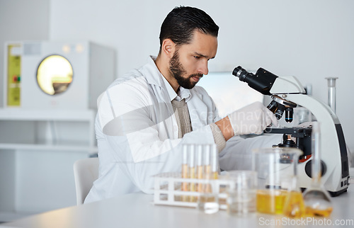 Image of Science, microscope and laboratory with a doctor man at work for research, innovation or development. Medical, analytics and biotechnology with a male scientist working in a lab for breakthrough