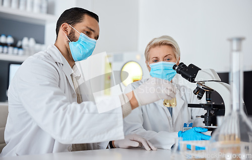 Image of Research, glass beaker and scientists working in laboratory for medical cure or vaccine. Innovation, teamwork and team of professional scientific experts with face mask in pharmaceutical science lab.