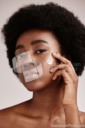 Image of Skincare, face and portrait of black woman with lotion, afro and advertising luxury skin care with collagen product promotion. Dermatology, cosmetic and facial for model isolated on studio background