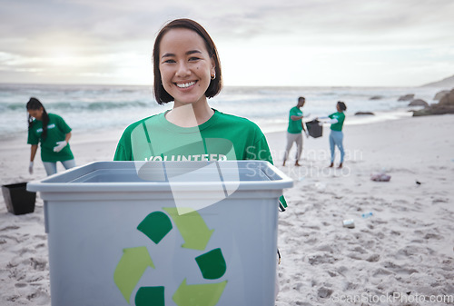 Image of Recycling bin, portrait of Asian woman and volunteer at beach cleaning for environmental sustainability. Recycle, earth day and happy female ready to stop pollution by ocean for community service.