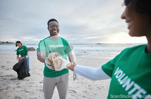 Image of Teamwork, help and recycling with people on beach for sustainability, environment and eco friendly. Climate change, earth day and nature with volunteer and cleaning for charity and community service