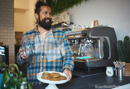 Image of Barista man, coffee shop and plate for cookies at small business with service, care and experience. Young entrepreneur, cafe and kindness with food, snack or dessert for energy, health and wellness