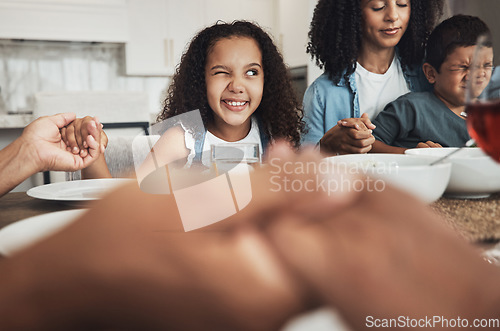 Image of Happy girl praying with her family for dinner at their home for religion, respect or compassion. Spiritual, gratitude and young child peeping while in a prayer at event, party or supper at her house.