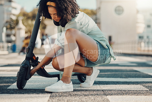 Image of Black woman, scooter and eco friendly travel in city, adventure and fixing the wheel of ebike outdoor. Sustainable transportation, freedom with carbon footprint and transport in urban street in Miami