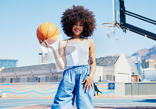 Image of Basketball court, city and portrait of black woman with smile in trendy, urban style and edgy clothes. Sports, fitness park and girl model outdoors with ball with confidence, happy and cool outfit