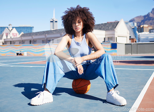 Image of Fashion, city and portrait of black woman with basketball court with trendy, urban style and edgy clothes. Sports, fitness park and girl pose outdoors with ball with confidence and attitude