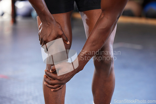 Image of Hands, knee pain and man at gym with injury, hurt or sore during fitness, training and exercise on mockup space. Sports, accident and legs of guy with muscle, arthritis or inflammation during workout