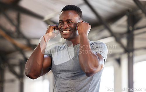 Image of Music, exercise and man at gym with earphones while training, cardio and fitness on mockup background. Radio, workout and black guy listening to podcast, track or audio at sports center for routine