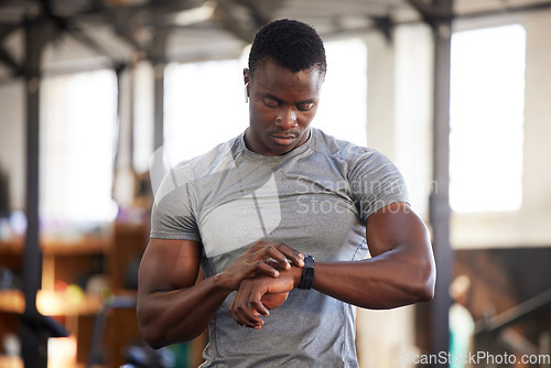 Image of Fitness, smartwatch and black man in gym for training, workout or exercise results, monitor or progress update, Check, timer and bodybuilder athlete or sports person technology in health and wellness