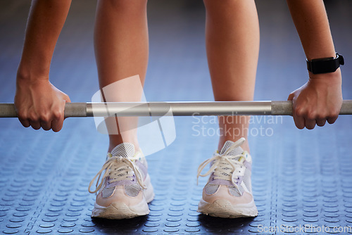 Image of Barbell, hands and woman exercise on floor for fitness, workout and sports challenge in gym. Closeup female athlete, bodybuilder and heavy weights on ground for deadlift, wellness and muscle power