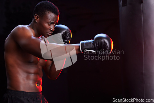 Image of Boxer, fitness and black man isolated on a dark background or gym training focus, challenge and bodybuilder fist impact. Strong, power and boxing athlete or sports person with exercise in mma gear