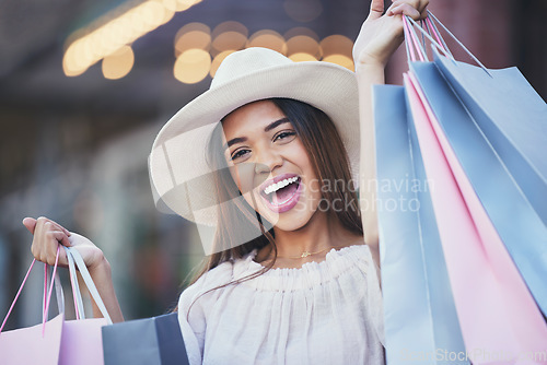 Image of Woman, shopping bags and portrait smile in the city carrying gifts for discount, deal or purchase. Happy female shopper or excited winner in joyful happiness for luxury, fashion or sale in urban town