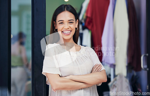 Image of Fashion, clothing store and portrait of a woman entrepreneur standing in her small business. Startup, confidence and happy female shop owner from Mexico with crossed arms in her luxury boutique.