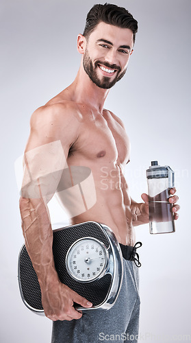 Image of Fitness, portrait or man with weight scale or water bottle in studio for training, exercise or workout for body goals. Healthy model, energy or happy sports athlete with smile, motivation or wellness