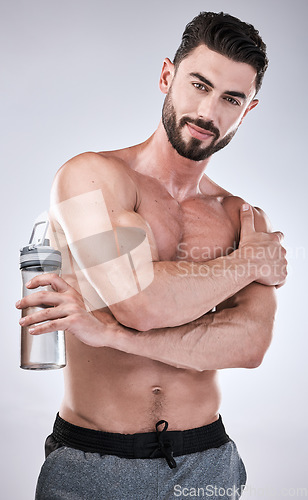 Image of Fitness, portrait or man with a water bottle in hand to start exercise, body training or gym workout. Sports athlete, model or healthy bodybuilder with motivation ready for exercising in studio